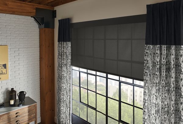 Solar shades filtering sunlight in a bright room